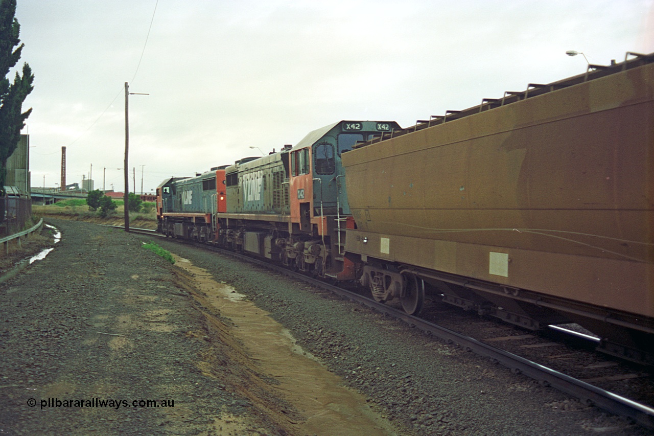 111-13
North Geelong C Box, V/Line broad gauge up Mt Gambier goods train 9192 heads around the Loop Line bound for Melbourne behind X class X 48 Clyde Engineering EMD model G26C serial 75-795 and X 42 serial 70-705, trailing view.
Keywords: X-class;X48;Clyde-Engineering-Rosewater-SA;EMD;G26C;75-795;