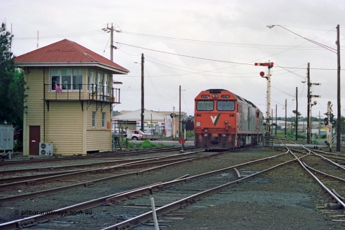 111-35
North Geelong C Box, V/Line broad gauge light engines Series 1 G class leader G 511 Clyde Engineering EMD model JT26C-2SS serial 84-1239 and G 538 Clyde Engineering EMD model JT26C-2SS serial 89-1271 shunt back into the yard past C box and splitting ground dwarf signal 18 and semaphore signal post 16, track view of levers and points, catch points, signal box and posts, destined for empty grain train 9123.
Keywords: G-class;G538;Clyde-Engineering-Somerton-Victoria;EMD;JT26C-2SS;89-1271;