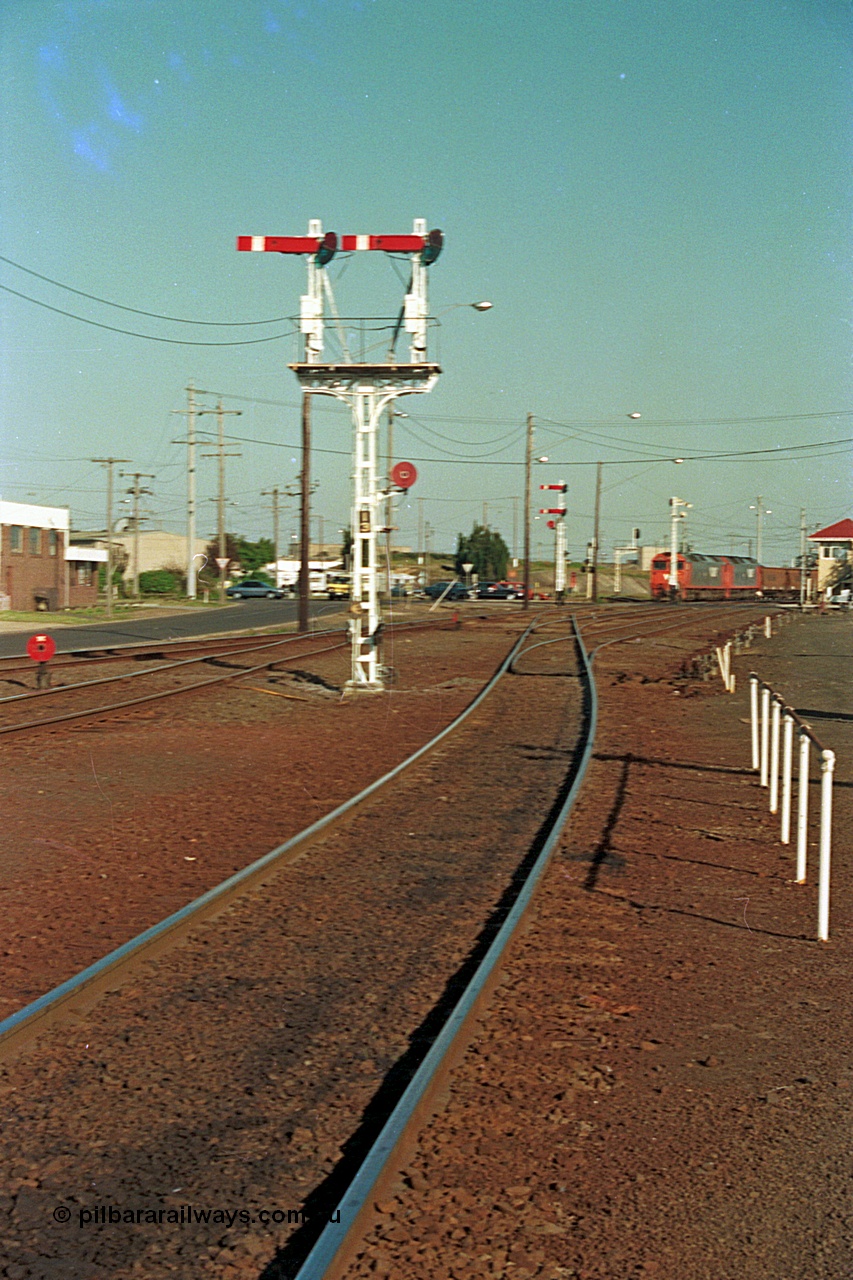 112-37
North Geelong C Box, looking east, semaphore signal post 13 freshly repainted, standing on broad gauge mainline to Gheringhap, grain arrivals at left, in the distance V/Line G class G 529 Clyde Engineering EMD model JT26C-2SS serial 88-1259 leads a departing grain train, off focus.
Keywords: G-class;G529;Clyde-Engineering-Somerton-Victoria;EMD;JT26C-2SS;88-1259;