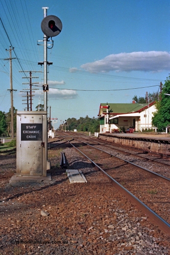 112-06
Violet Town broad gauge track view looking north, station overview, staff exchange cabin and cover for ground apparatus, cabin used when signal box is switched out, searchlight signal post 7, station building and signal bay, semaphore signal post 9 on platform, March 1994.
