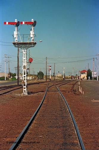 112-16
North Geelong yard overview, looking east, semaphore signal post 13 freshly repainted, signal posts 15 and 16 visible in the background, North Geelong C Box at right, standing on broad gauge mainline to Gheringhap, grain arrivals at left.
