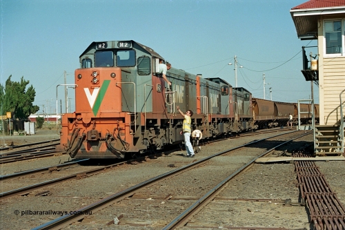 112-31
North Geelong C Box, V/Line broad gauge H class locos H 2 Clyde Engineering EMD model G18B serial 68-630, H 5 serial 68-632 and H 4 serial 68-633 shunt empty an grain train rake back into North Geelong yard, past C Box as the driver surrenders the staff to the signaller for the Grain Loop, safeworking, point rodding.
Keywords: H-class;H2;Clyde-Engineering-Granville-NSW;EMD;G18B;68-630;H5;68-632;H4;68-633;