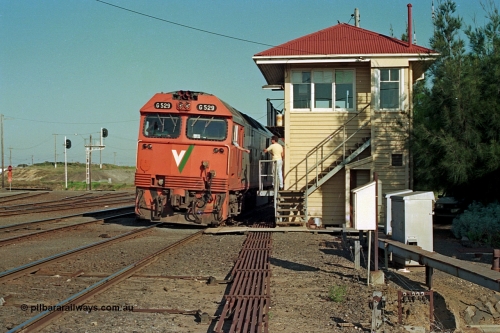 112-35
North Geelong C Box, V/Line broad gauge light engines G class G 529 Clyde Engineering EMD model JT26C-2SS serial 88-1259 and sister have just surrendered the electric staff for Nth Geelong B to Nth Geelong C section to the signaller at C Box signal man, safeworking, point rodding, staff exchange, track view, signal box.
Keywords: G-class;G529;Clyde-Engineering-Somerton-Victoria;EMD;JT26C-2SS;88-1259;