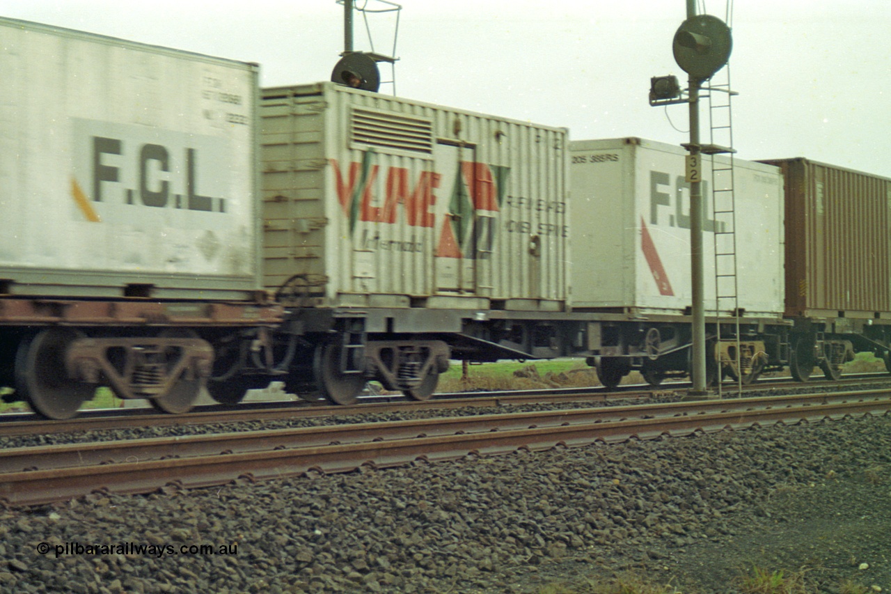 113-21
Parwan Loop, V/Line broad gauge container waggon with genset container for powering refrigerated containers, part of up Adelaide goods train 9150, in miserable conditions, poor quality.
