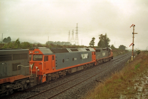 113-06
Warrenheip, up home semaphore signal post 11, V/Line broad gauge up Adelaide goods train 9150 grinds upgrade behind C class C 506 Clyde Engineering EMD model GT26C serial 76-829, G class G 538 Clyde Engineering EMD model JT26C-2SS serial 89-1271 and C class C 510 serial 76-833, in miserable conditions, poor quality off focus.
Keywords: G-class;G538;Clyde-Engineering-Somerton-Victoria;EMD;JT26C-2SS;89-1271;