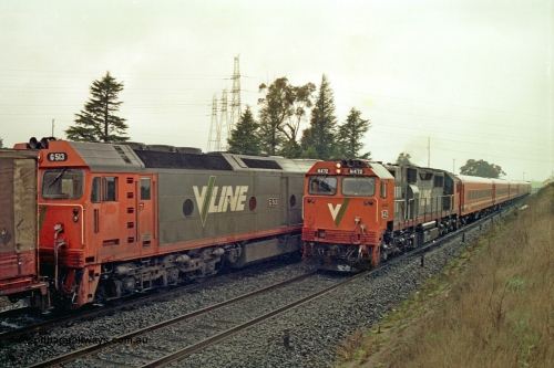 113-09
Warrenheip, V/Line broad gauge up Adelaide goods train 9150 with forth unit visible G class G 513 Clyde Engineering EMD model JT26C-2SS serial 85-1241, is crossed by down passenger train hauled by N class N 472 'City of Sale' Clyde Engineering EMD model JT22HC-2 serial 87-1201 and a double N set, in miserable conditions, poor quality.
Keywords: N-class;N472;Clyde-Engineering-Somerton-Victoria;EMD;JT22HC-2;87-1201;