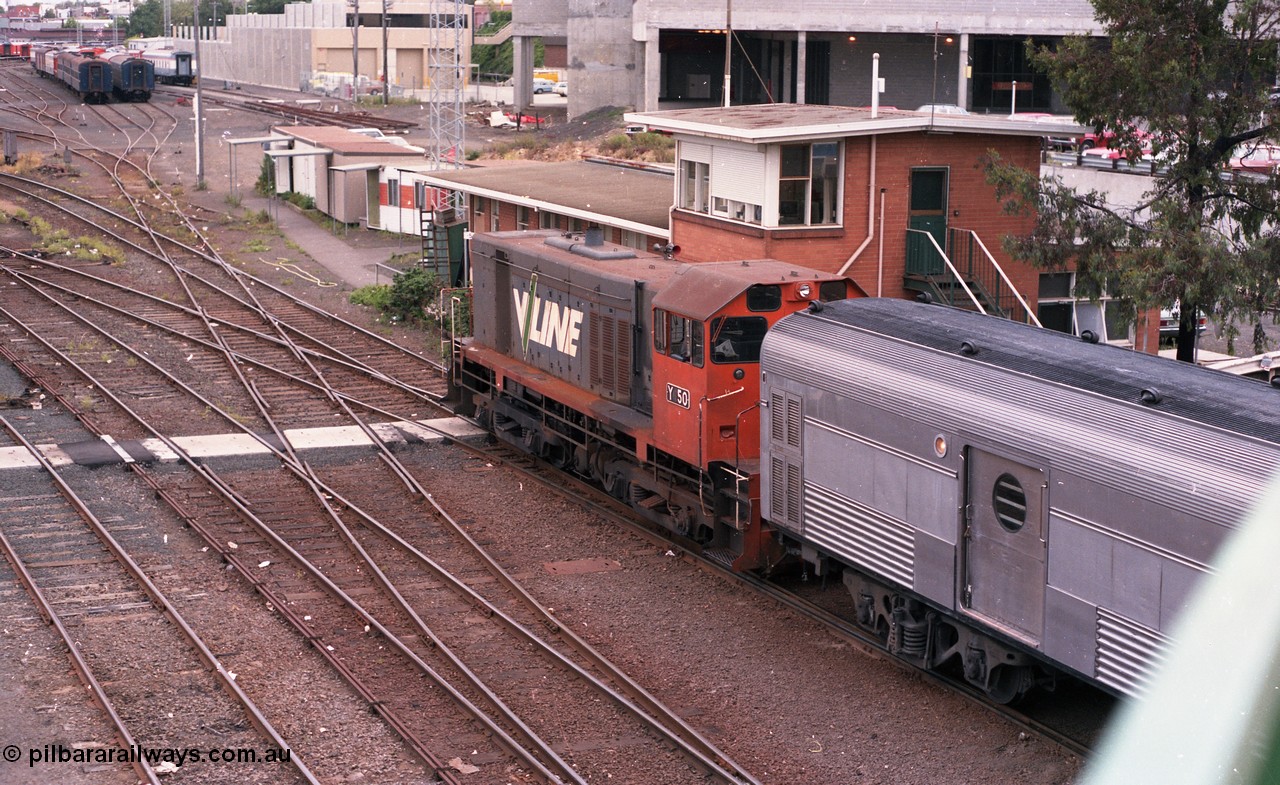 116-03
Spencer Street Station, view looking south from flyover with Motorail waggon on 'The Overland' at platform No.2, with stabled diesel electric rail motors, or DERMs 55 RM and 54 RM, with H set SH 29, overlooking the Melbourne Yard, West Tower is visible to the right.
