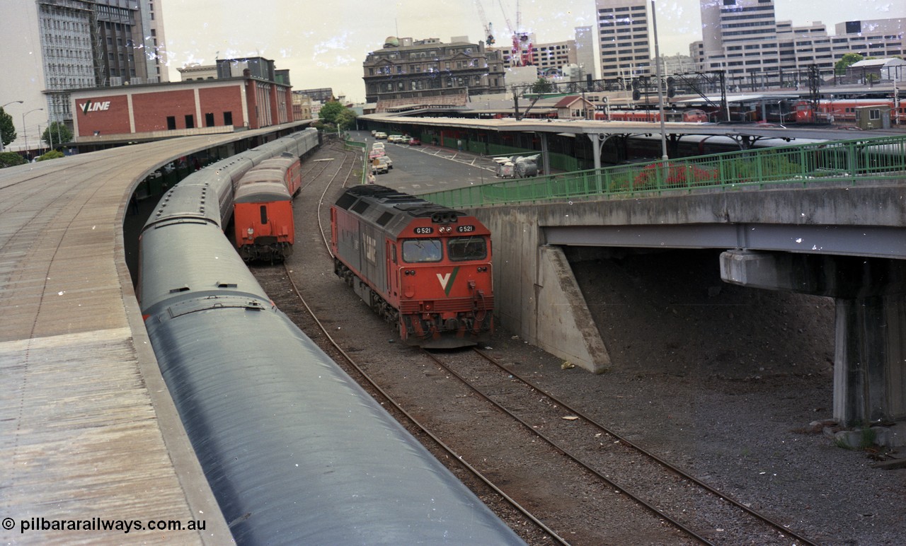 116-14
Spencer Street Station, view from flyover looking north, dual gauge Platform No.1 with Melbourne Express carriage set, a stabled V/Line broad gauge H set in the East Passenger Yard siding and standard gauge V/Line G class G 521 Clyde Engineering EMD model JT26C-2SS serial 85-1234 runs light engine to South Dynon having cut off from the Melbourne Express.
Keywords: G-class;G521;Clyde-Engineering-Rosewater-SA;EMD;JT26C-2SS;85-1234;