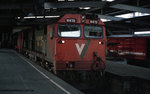 116-02
Spencer Street Station Platform No.2, V/Line broad gauge N class locos N 472 Clyde Engineering EMD model JT22HC-2 serial 87-1201 City of Sale and a sister have cut off 'The Overland' overnight train from Adelaide and idle away in the dock as the yard pilot shunts off the Motorail waggons.
Keywords: N-class;N472;Clyde-Engineering-Somerton-Victoria;EMD;JT22HC-2;87-1201;