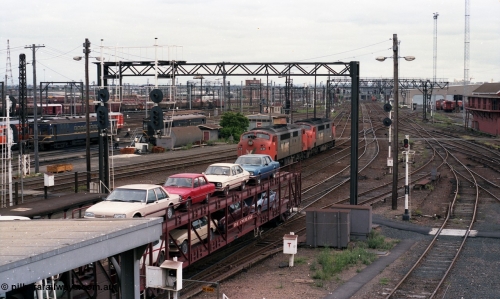 116-07
Spencer Street Station, view looking south from flyover, V/Line broad gauge A class A 62 runs light engine, in the background is a 'Tea Cup' V/Line liveried N set couple to current V/Line liveried N set, in the background are stored Y and T class locomotives.
