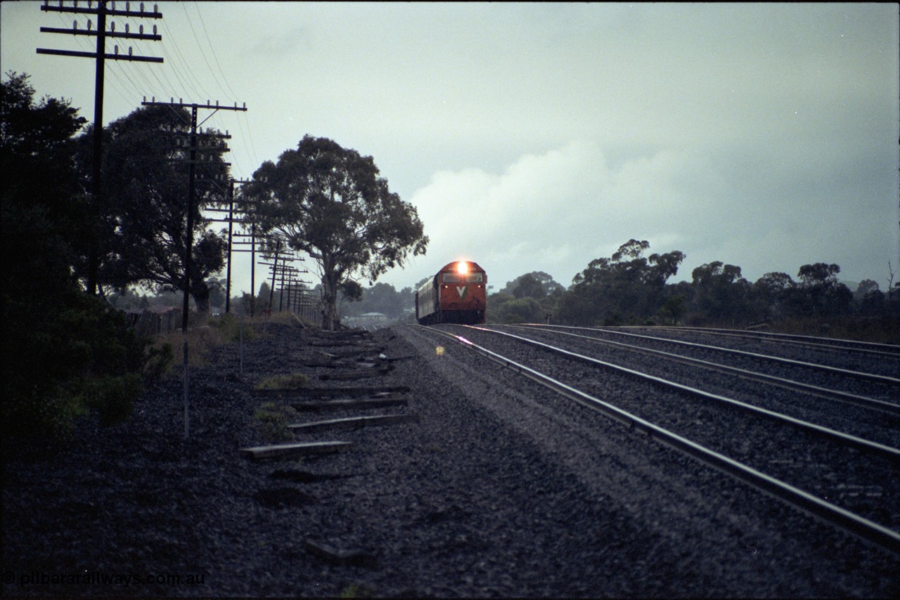 117-01
Somerton, V/Line N class loco N 456 'City of Colac' with serial 85-1224 a Clyde Engineering Somerton Victoria built EMD model JT22HC-2 with up Albury Pass train, standard gauge line on far right, in driving rain.
Keywords: N-class;N456;Clyde-Engineering-Somerton-Victoria;EMD;JT22HC-2;85-1224;
