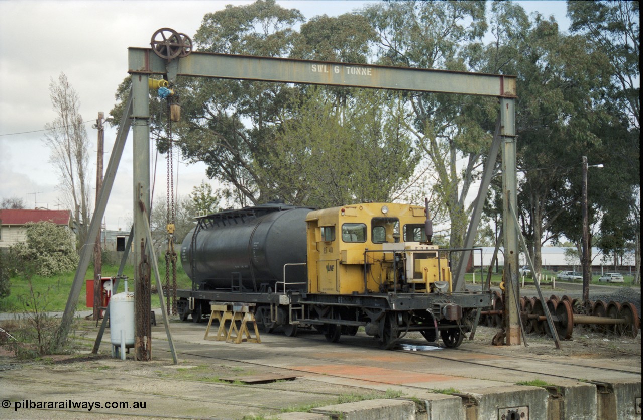 117-33
Seymour loco depot, turntable roads, rail tractor RT class RT 40 Victorian Railways yellow livery with V/Line decal, oil tank bogie waggon, under gantry.
Keywords: RT-class;RT40;