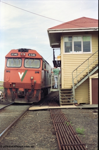 119-07
Nth Geelong C Box, V/Line broad gauge light engines G class G 540 Clyde Engineering EMD model JT26C-2SS serial 89-1273 handing up the electric staff from Nth Geelong B, safeworking, point rodding, signal box.
Keywords: G-class;G540;Clyde-Engineering-Somerton-Victoria;EMD;JT26C-2SS;89-1273;
