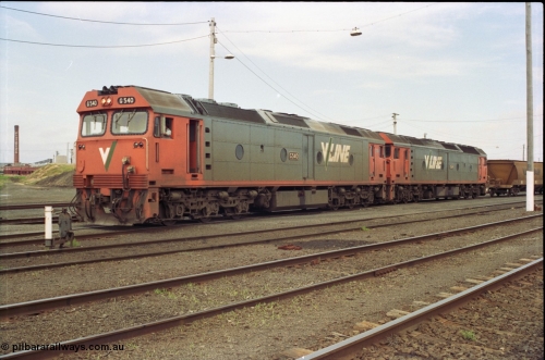119-08
North Geelong yard, V/Line broad gauge locos G class G 540 Clyde Engineering EMD model JT26C-2SS serial 89-1273 and another G class waiting for shunters to couple up to empty grain rake to form down grain train 9125, ground dwarf signal 20.
Keywords: G-class;G540;Clyde-Engineering-Somerton-Victoria;EMD;JT26C-2SS;89-1273;