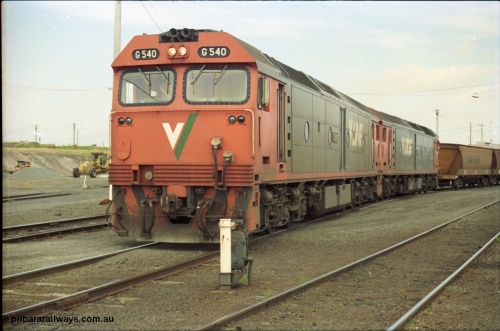 119-09
North Geelong yard, V/Line broad gauge locos G class G 540 Clyde Engineering EMD model JT26C-2SS serial 89-1273 and another G class waiting for shunters to couple up to empty grain rake to form down grain train 9125, ground dwarf signal 20.
Keywords: G-class;G540;Clyde-Engineering-Somerton-Victoria;EMD;JT26C-2SS;89-1273;