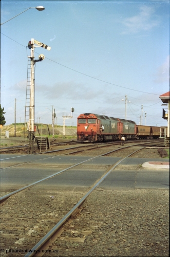 119-11
North Geelong C Box, V/Line broad gauge G classes G 540 Clyde Engineering EMD model JT26C-2SS serial 89-1273 and sister depart with down empty grain train 9125, looking across Separation Street, semaphore signal post 16 is pulled off for move, grade crossing, 2nd person climbing aboard with staff.
Keywords: G-class;G540;Clyde-Engineering-Somerton-Victoria;EMD;JT26C-2SS;89-1273;