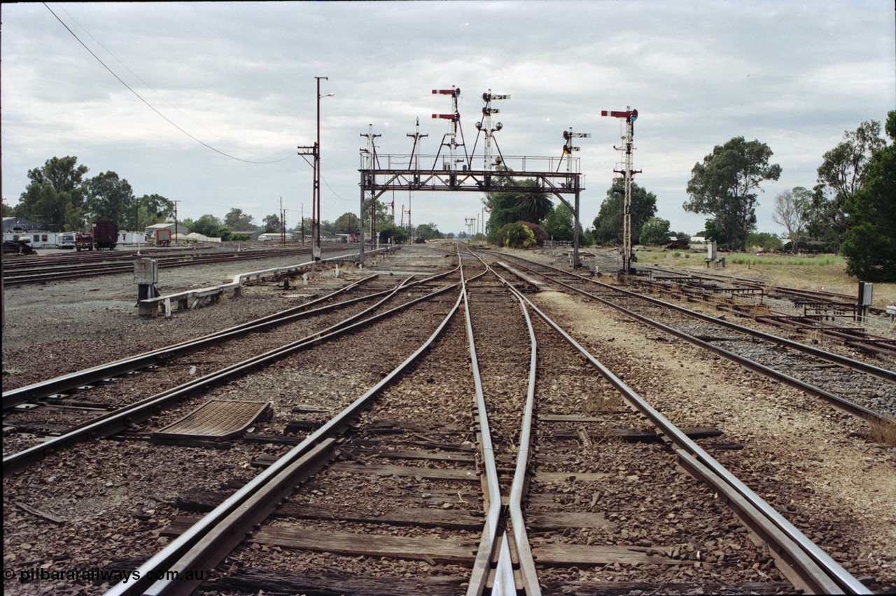 120-19
Benalla station yard, looking north, semaphore signal post 27 and gantry stripped dolls, tracks removed.
