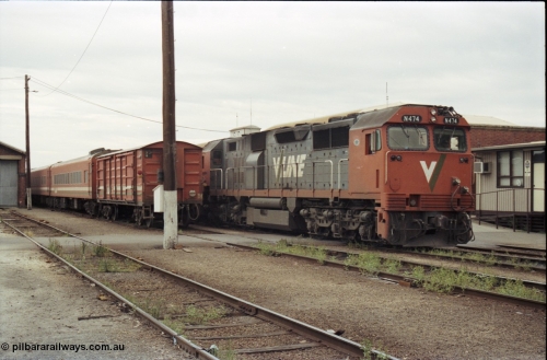 120-30
Wodonga yard, stabled passenger consists, V/Line broad gauge loco N class N 474 'City of Traralgon' Clyde Engineering EMD model JT22HC-2 serial 87-1203, next to a D van.
Keywords: N-class;N474;Clyde-Engineering-Somerton-Victoria;EMD;JT22HC-2;87-1203;