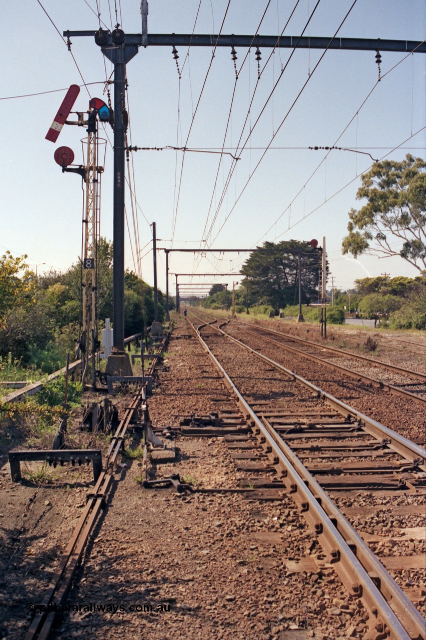 121-29
Morwell, eastern end of yard view, looking towards Traralgon, semaphore signal Post 8 and disc signal Post 9, SEC Briquette Sidings on the right, mainline to Traralgon on the left. Post 8 pulled off for mainline, point rodding, interlocking and signal wires.
