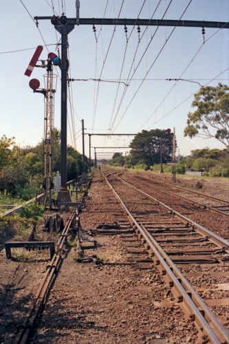 121-29
Morwell, eastern end of yard view, looking towards Traralgon, semaphore signal Post 8 and disc signal Post 9, SEC Briquette Sidings on the right, mainline to Traralgon on the left. Post 8 pulled off for mainline, point rodding, interlocking and signal wires.

