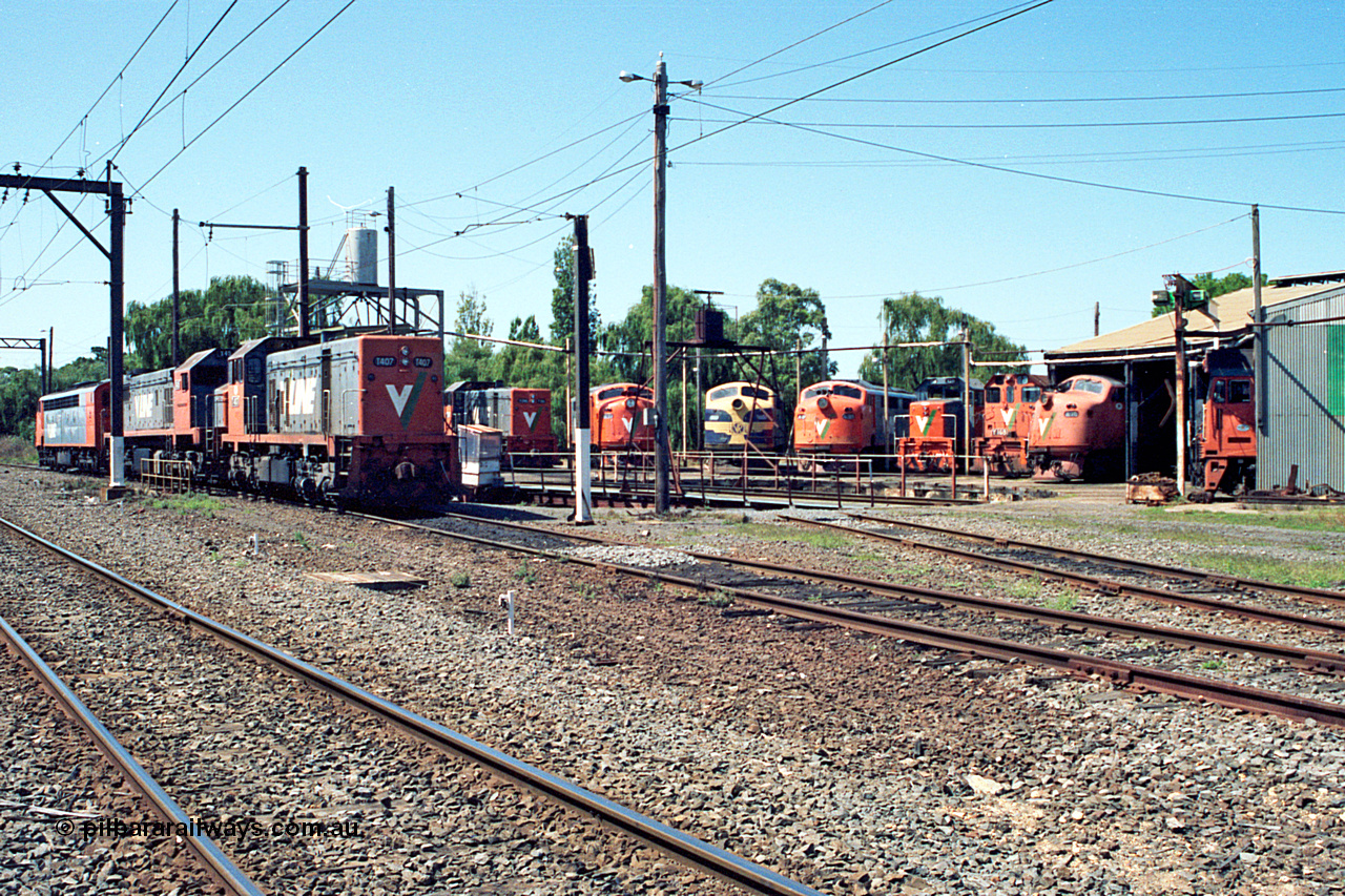 122-06
Traralgon loco depot overview, turntable and roundhouse, V/Line broad gauge loco classes present are all Clyde Engineering EMD models: T class G8B and G18B. X class G26C. A class AAT22C-2R rebuilt from ML2. B class ML2. Y class G6B. G class JT26C-2SS and S class A7. March 1992.
