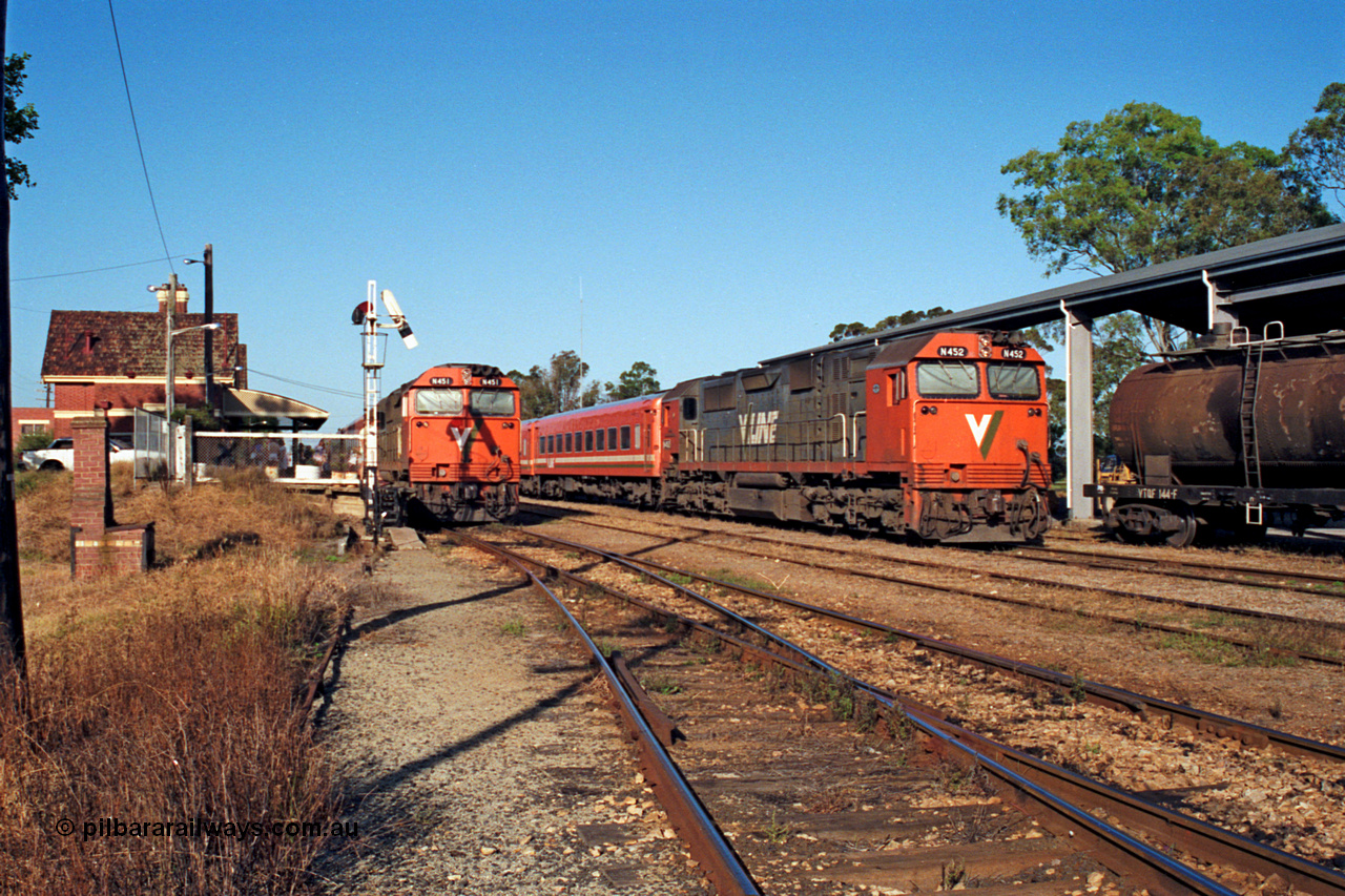 123-1-10
Bairnsdale station overview, V/Line broad gauge N class leader N 451 'City of Portland' Clyde Engineering EMD model JT22HC-2 serial 85-1219 with an up passenger train and N class N 452 'Rural City of Wodonga' serial 85-1220 with a stabled pass in the yard, signal post, VTQF type tank waggon VTQF 144.
Keywords: N-class;N451;Clyde-Engineering-Somerton-Victoria;EMD;JT22HC-2;85-1219;VTQF-type;VTQF144;
