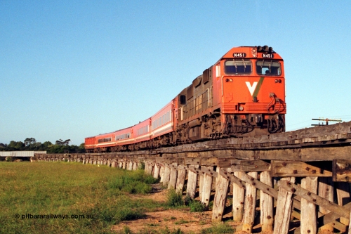 123-1-19
Avon River steel bridge at left, trestle bridge over flood plain, V/Line broad gauge N class N 451 'City of Portland' Clyde Engineering EMD model JT22HC-2 serial 85-1219, N set, up Bairnsdale pass.
Keywords: N-class;N451;Clyde-Engineering-Somerton-Victoria;EMD;JT22HC-2;85-1219;