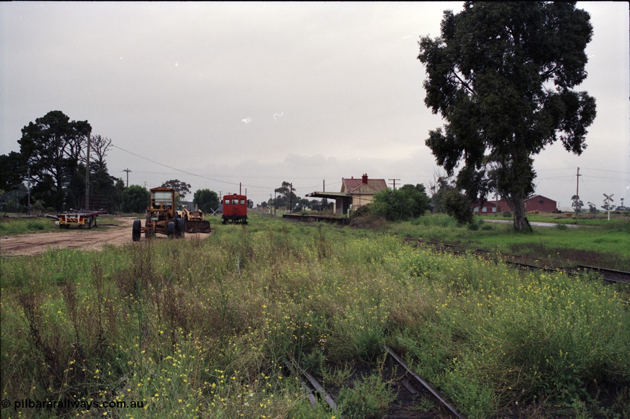 123-2-07
Maffra station overview, looking from Tinamba end of yard, broad gauge V/Line RT class rail tractor RT 49 started out as I waggon 7507 built by Victorian Railways 21-02-1905, converted to IA in 1936, then K 85 in April 1955 and in 1969 to the underframe of RT 49 by Ballarat North Workshops, Siding A sheds at right of frame, yard overgrown, motor grader, station building.
Keywords: RT-class;RT49;I-type;IA-type;I7507;IA7507;K-type;K85;