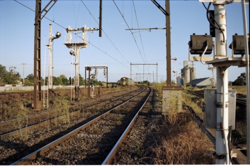 124-14
Sunshine looking from the passenger lines across to the Independent Through Goods lines, signal post 71 at camera, disc and semaphore signal posts 31 and 31B for control of the Independent Trough Goods lines, down Adelaide broad gauge goods train on approach behind BL classes BL 30 and BL 35 in AN livery, standard gauge Sunshine Loop to the left of train, Newport Loop Line and GEB sidings at far right
