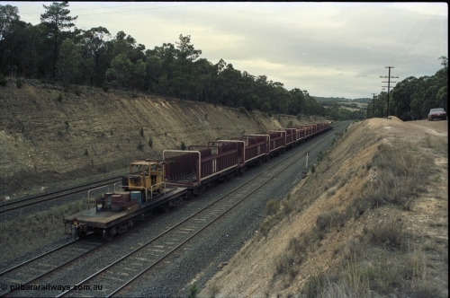 125-23
Heathcote Junction, V/Line broad gauge B class Clyde Engineering EMD model ML2 serial ML2-6 still in Victorian Railways livery leads a sleeper discharge train on the up broad gauge line, rolling down towards Wallan, trailing shot, V/Line VZSX class bogie sleeper waggons, train half empty, sleeper discharge machine.
