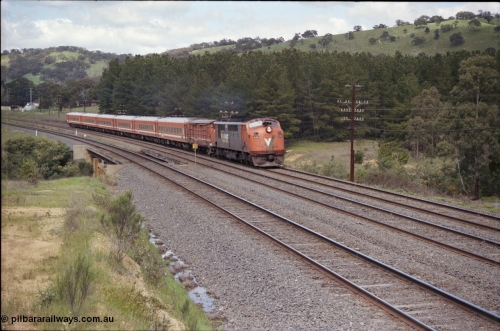 126-34
Kilmore East, Sunday Creek Rd overbridge, V/Line A class A 70 Clyde Engineering EMD model AAT22C-2R serial 84-1187 rebuilt from B 70 Clyde Engineering EMD model ML2 serial ML2-11 and N set, down broad gauge Albury pass.
Keywords: A-class;A70;Clyde-Engineering-Rosewater-SA;EMD;AAT22C-2R;84-1187;rebuild;bulldog;