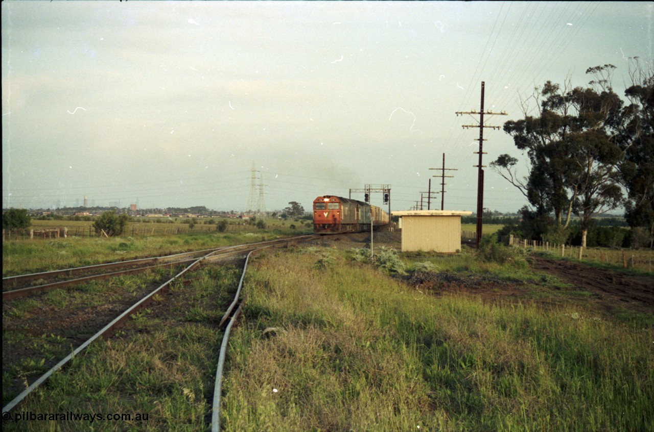 127-26
Deer Park West, view looking to Melbourne from the broad gauge line to Boral Quarries, with Adelaide bound goods pulling on to the main line at the end of the double track behind V/Line G class G 512 Clyde Engineering EMD model JT26C-2SS serial 84-1240 and Australian National BL class BL 27 Clyde Engineering EMD model JT26C-2SS serial 83-1011
Keywords: G-class;G512;Clyde-Engineering-Rosewater-SA;EMD;JT26C-2SS;84-1240;
