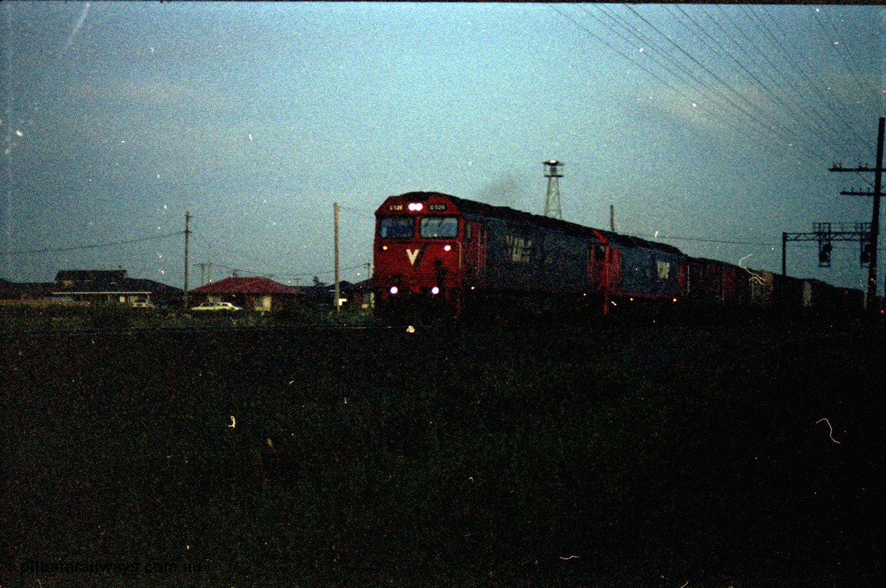127-30
Deer Park West, broad gauge V/Line G class G 526 Clyde Engineering EMD model JT26C-2SS serial 88-1256 leads another G class with a down Adelaide goods train as it crosses Robinson's Road, very dark.
Keywords: G-class;G526;Clyde-Engineering-Somerton-Victoria;EMD;JT26C-2SS;88-1256;