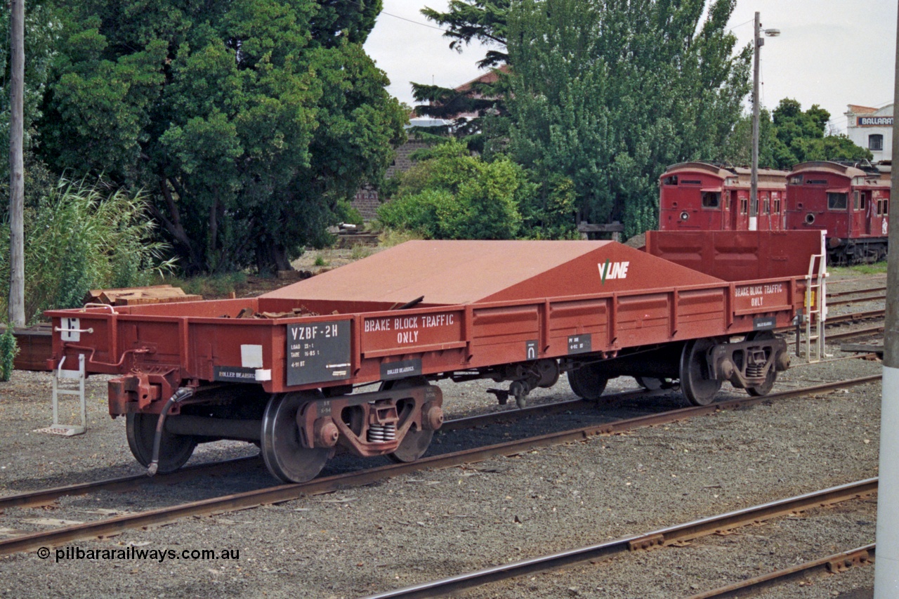 128-02
Ballarat yard, broad gauge V/Line VZBF type bogie brake block transport waggon VZBF 2, a 1990 conversion from what was originally an Victorian Railways BP type steel mail van BP 77 built in 1959 at Newport Workshops as part of a batch of eighty three. It went on to be recoded to BB 222 in December 1960, then BMF 2 in December 1961, BMX 2 in February 1968, recoded to VBAX in 1979, then in 1990 converted to the VZBF along with two other waggons as a group of three. Tait carriages in background.
Keywords: VZBF-type;VZBF2;Victorian-Railways-Newport-WS;BP-type;BP77;BB-type;BB222;BMF-type;BMF2;BMX-type;BMX2;VBAX-type;VBAX2;