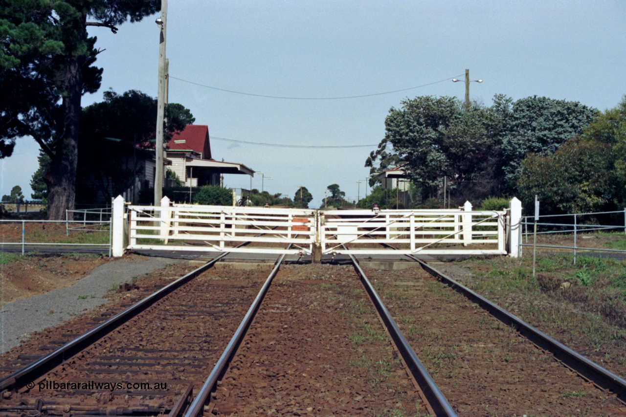 128-19
Gisborne, Gisborne Road grade crossing, non-interlocked swing gates, looking south in the Up direction, across road is the station building, track view.
