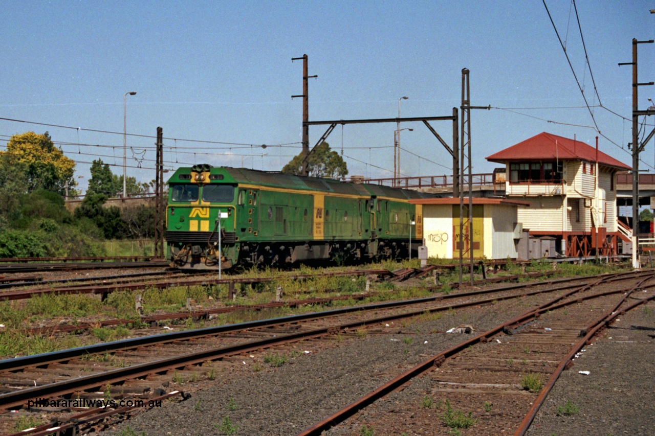 129-1-07
Sunshine, Australian National BL classes BL 33 Clyde Engineering EMD model JT26C-2SS serial 83-1017 and BL 32 serial 83-1016 in AN livery, lead a broad gauge down Adelaide goods train along No.2 Rd onto the South Line, signal box, points and point rodding, Sunshine still mechanically interlocked.
Keywords: BL-class;BL33;Clyde-Engineering-Rosewater-SA;EMD;JT26C-2SS;83-1017;
