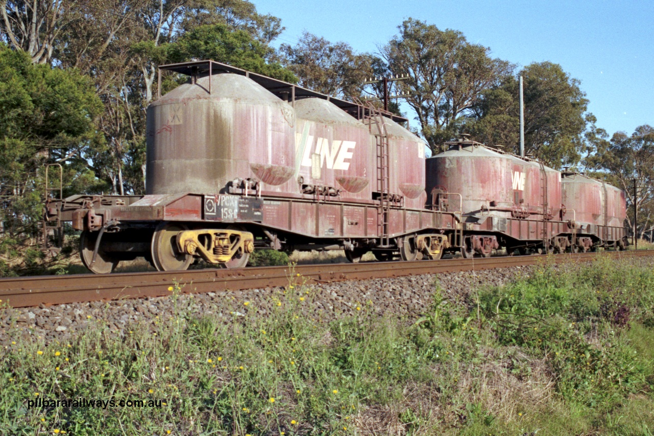 129-1-11
Lyndhurst, V/Line broad gauge VPCX type bogie air discharge cement hopper waggons VPCX 158, shows two styles of roof platforms. VPCX 158 is the final member of a batch of fifty (109-158) built at Bendigo Workshops in 1981/82. Re-classed in 1996 to VPBX. Location is [url=https://goo.gl/maps/APmJrHjskZH4gvxa6]Geo Data[/url].
Keywords: VPCX-type;VPCX158;VPBX-type;