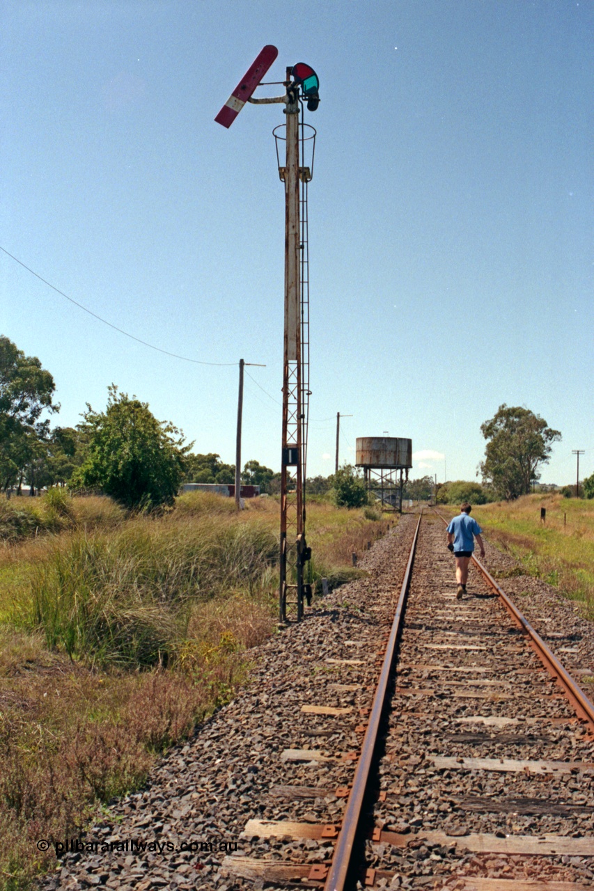129-2-13
Nyora track view, semaphore signal post 1 down home, water tank, looking down direction towards Nyora, loco depot track in the cutting at left.
