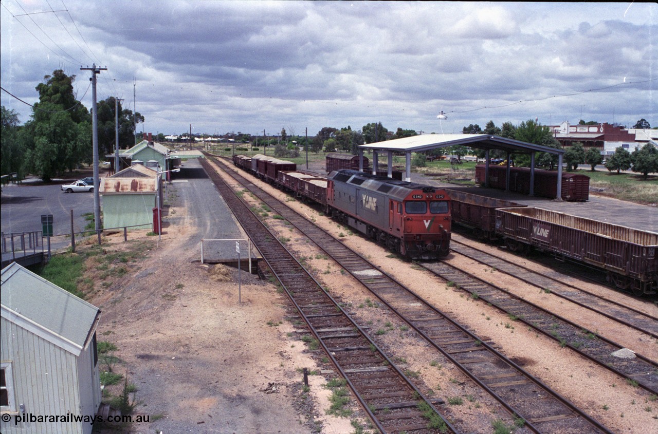 132-03
Ouyen station overview, broad gauge V/Line G class G 540 Clyde Engineering EMD model JT26C-2SS serial 89-1273 with stabled up gypsum train 9138, looking south from footbridge, station building and platform, Freightgate canopy with grounded waggons.
Keywords: G-class;G540;Clyde-Engineering-Somerton-Victoria;EMD;JT26C-2SS;89-1273;