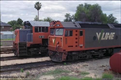 132-26
Mildura loco depot V/Line broad gauge X class X 32 Clyde Engineering EMD model G16C serial 66-485 and G class G 512 Clyde Engineering EMD model JT26C-2SS serial 84-1240, cab side view.
Keywords: G-class;G512;Clyde-Engineering-Rosewater-SA;EMD;JT26C-2SS;84-1240;X-class;X32;G16C;66-485;