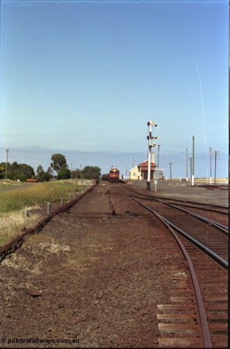 133-31
Gheringhap station yard overview, looking from Ballarat line points towards Geelong, semaphore signal post 4 pulled off for Cressy line, points, point rodding, signal wires and interlocking, V/Line broad gauge grain train 9123 swapping electric staff for train order for Maroona, safeworking.
Keywords: G-class;G533;Clyde-Engineering-Somerton-Victoria;EMD;JT26C-2SS;88-1263;