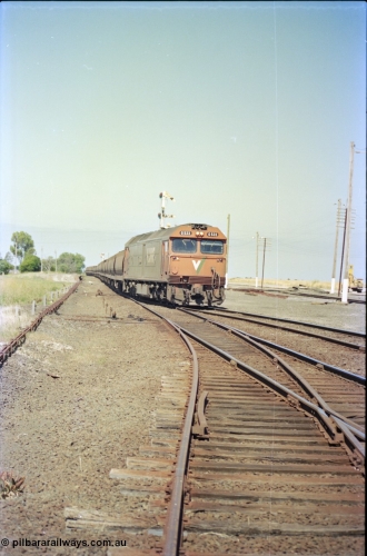 133-34
Gheringhap station yard overview, looking from Ballarat line points, semaphore signal post 4 pulled off for Cressy line, points, point rodding, signal wires and interlocking, V/Line broad gauge down empty grain train 9123 behind G class loco G 533 Clyde Engineering EMD model JT26C-2SS serial 88-1263 onto the Cressy line.
Keywords: G-class;G533;Clyde-Engineering-Somerton-Victoria;EMD;JT26C-2SS;88-1263;
