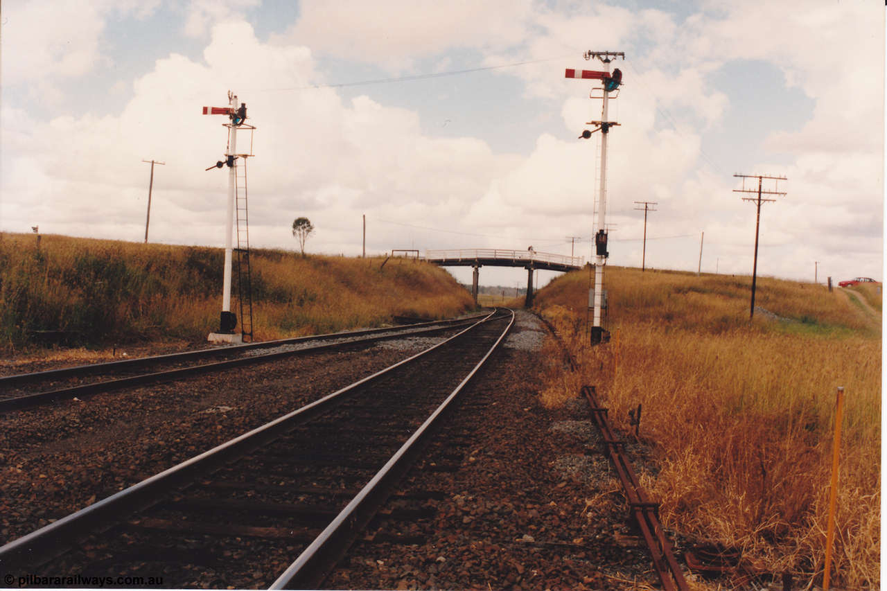 134-03
Kagaru, up departure signals, looking south at the south end, road over bridge, point rodding.
