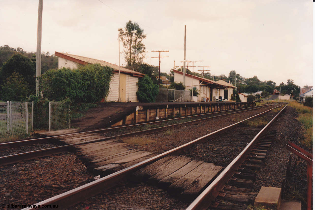134-18
Kyogle, station building overview, goods shed, waiting room, signal box, timber crossing, platform, looking south.
