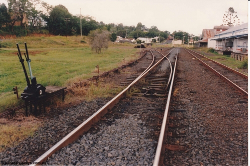 134-21
Kyogle, yard overview, looking south from middle of loop, ground frame D for siding, point rodding and interlocking, ex rail served buildings on right.
