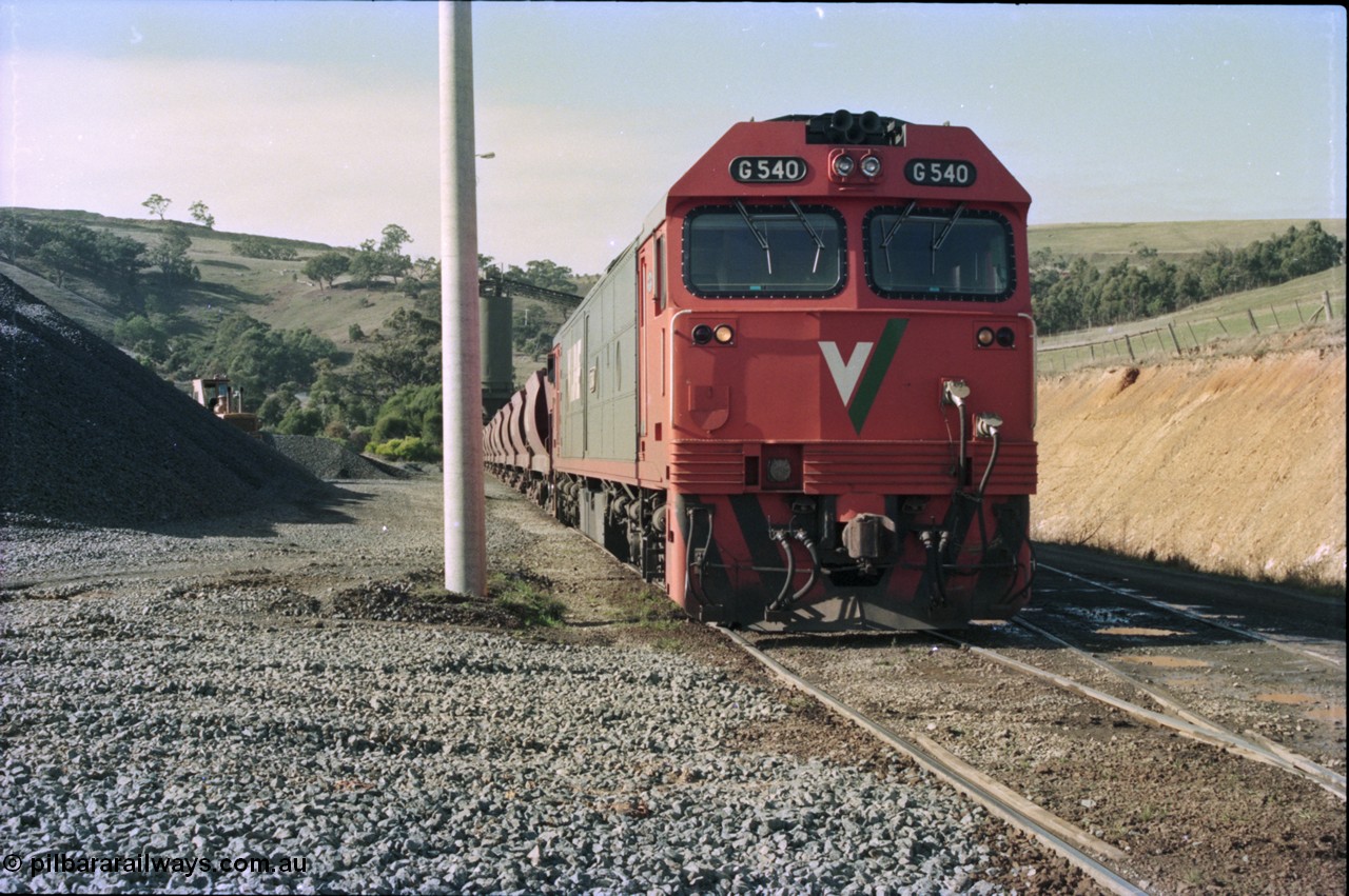 135-18
Kilmore East Apex Quarry siding, V/Line broad gauge G class G 540 Clyde Engineering EMD model JT26C-2SS serial 89-1273 on the front of the stone train as it is loaded by the front-end wheel loader.
Keywords: G-class;G540;Clyde-Engineering-Somerton-Victoria;EMD;JT26C-2SS;89-1273;