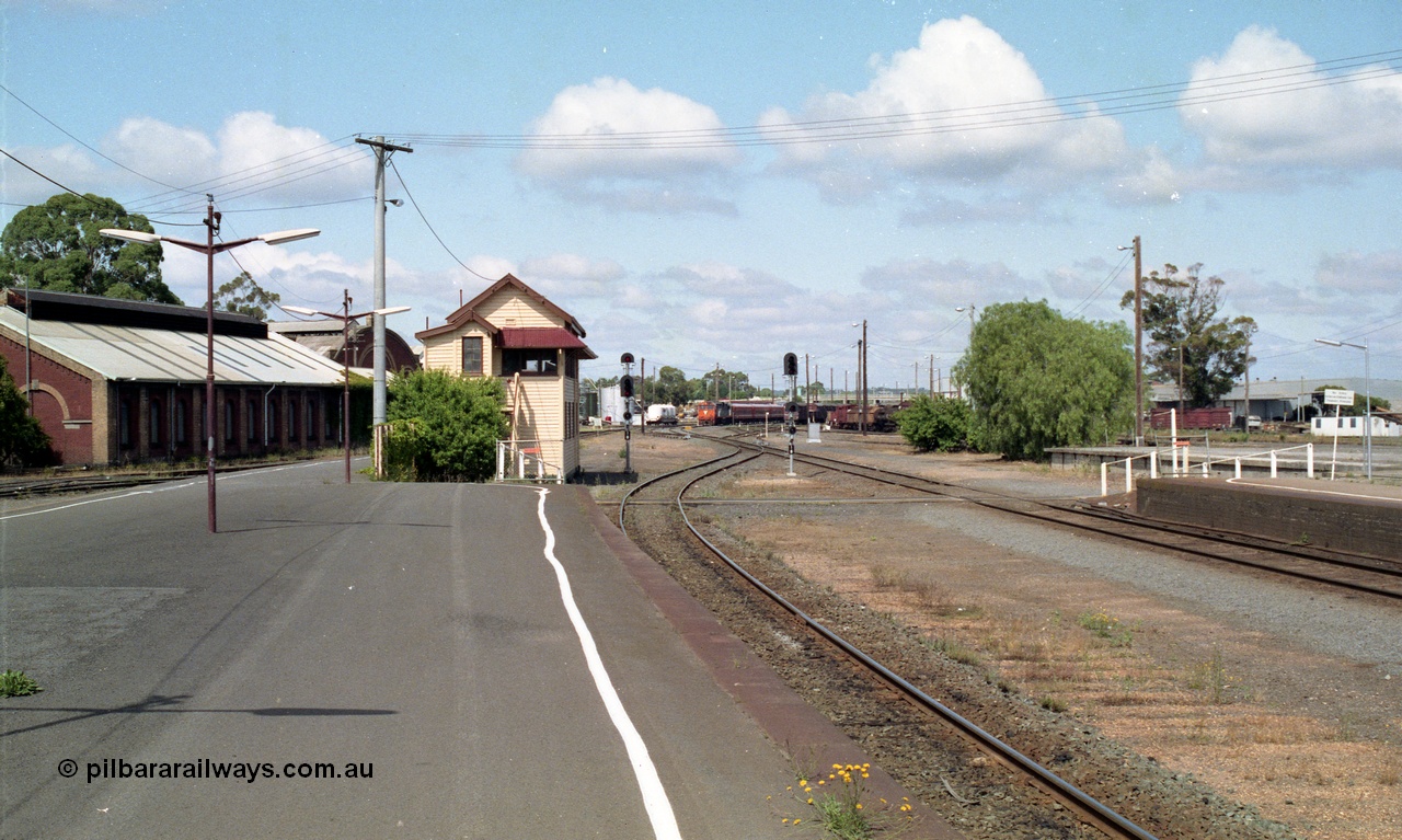 138-11
Bendigo station overview looking south past Bendigo A box, workshops at left, yard has been rationalised and mechanical signalling removed, N class arriving with down passenger in the background.
