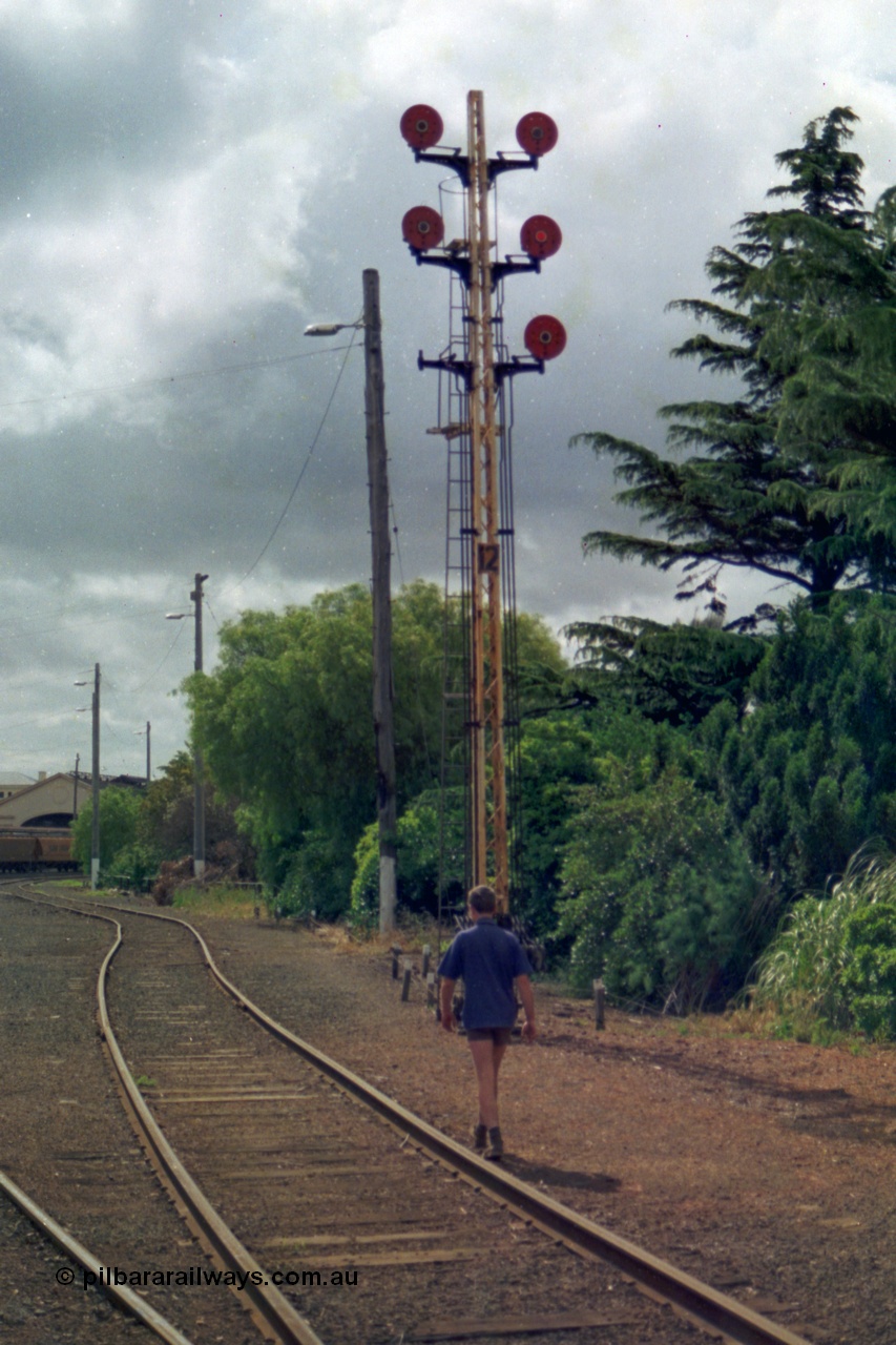 139-12
Ballarat yard disc signal Post 12 originally had six semaphores then six discs and in 1991 it was down to five discs. Not long after this view was taken the interlocked yard at Ballarat was rationalised and electrified with point motors and colour light signals taking over and all the old interlocked sidings had their interlocking removed. The top left hand Disc to the Car Sidings behind the station, centre left Disc towards Post No. 21 for No. 1 Road, removed bottom left Disc was towards Post No. 22 for No. 2 Road (also removed), top right hand Disc to Post No. 23 for No. 3 Road, centre right Disc towards Post No. 20 for No. 4 Road and the bottom right Disc to point 'D' towards Post No. 14 which led into the back road and the goods sheds and platforms.
