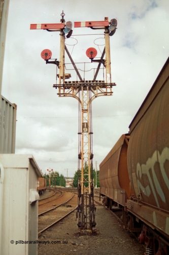 139-05
Ballarat yard, semaphore and disc signal Post 19 controlled from Ballarat Signal Box A or Ballarat Box, goods shed roads at left, goods platform roads at right, looking east. Right hand Arm Up Home No. 6 Road to the Up Passenger Line to Post 7, right hand Disc from No. 6 Road to 'D' towards Post 13, left hand Arm Up Home No. 7 Road to Up Passenger Line to Post 7 and left hand Disc from No. 7 Road to 'D' towards Post 13. The waggons at right are on No. 7 Road with the just visible grain waggons on No. 8 goods road with double disc Post 18.
