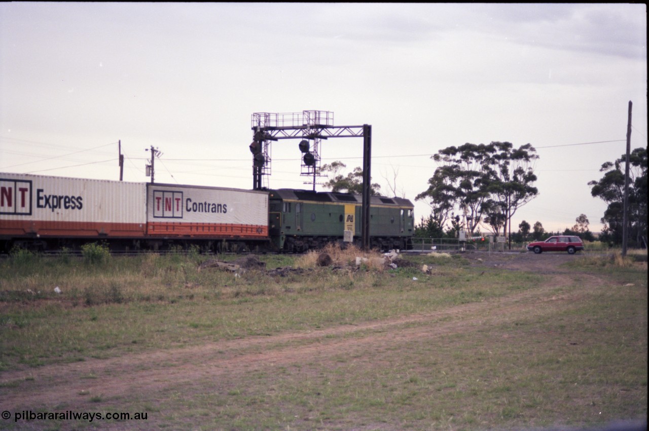 140-2-22
Deer Park West, Robinsons Road grade crossing, Australian National broad gauge BL class locomotive Clyde Engineering EMD model JT26C-2SS in AN livery leading a down Adelaide bound goods train.
Keywords: BL-class;Clyde-Engineering-Rosewater-SA;EMD;JT26C-2SS;